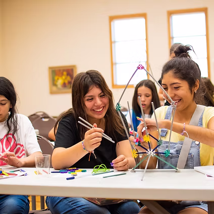 Students engaged in hands-on STEAM activities, exploring science, technology, engineering, arts, and mathematics